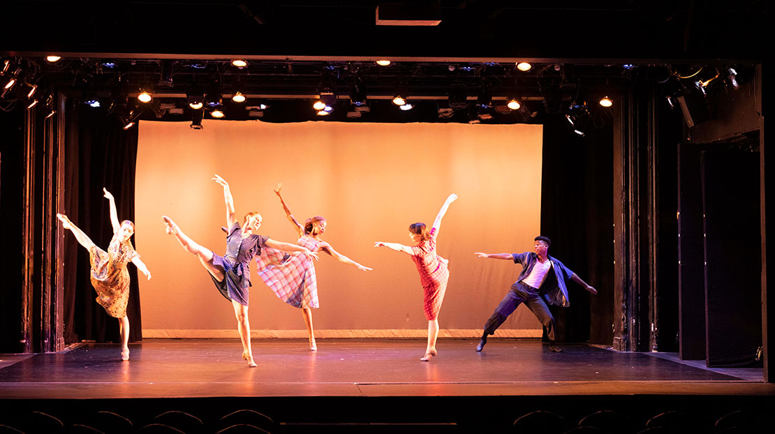 Five dancers in brightly colored costumes extend their legs to the side and arms in the air in Way Beyond the Blue, choreographed by Lois Enders.