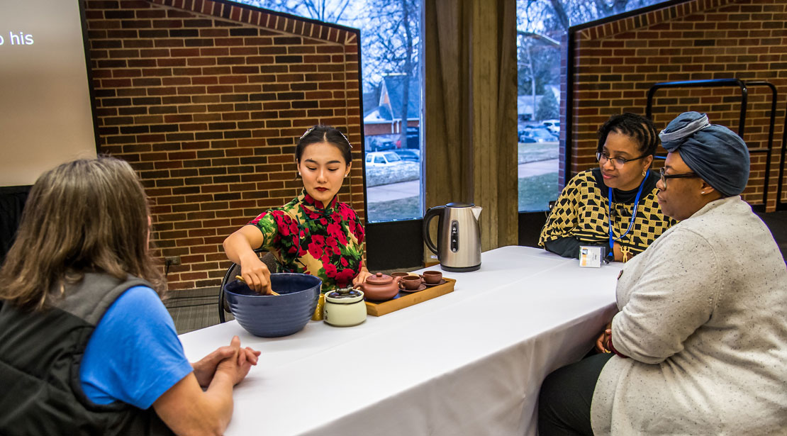 three participants observe a tea ceremony