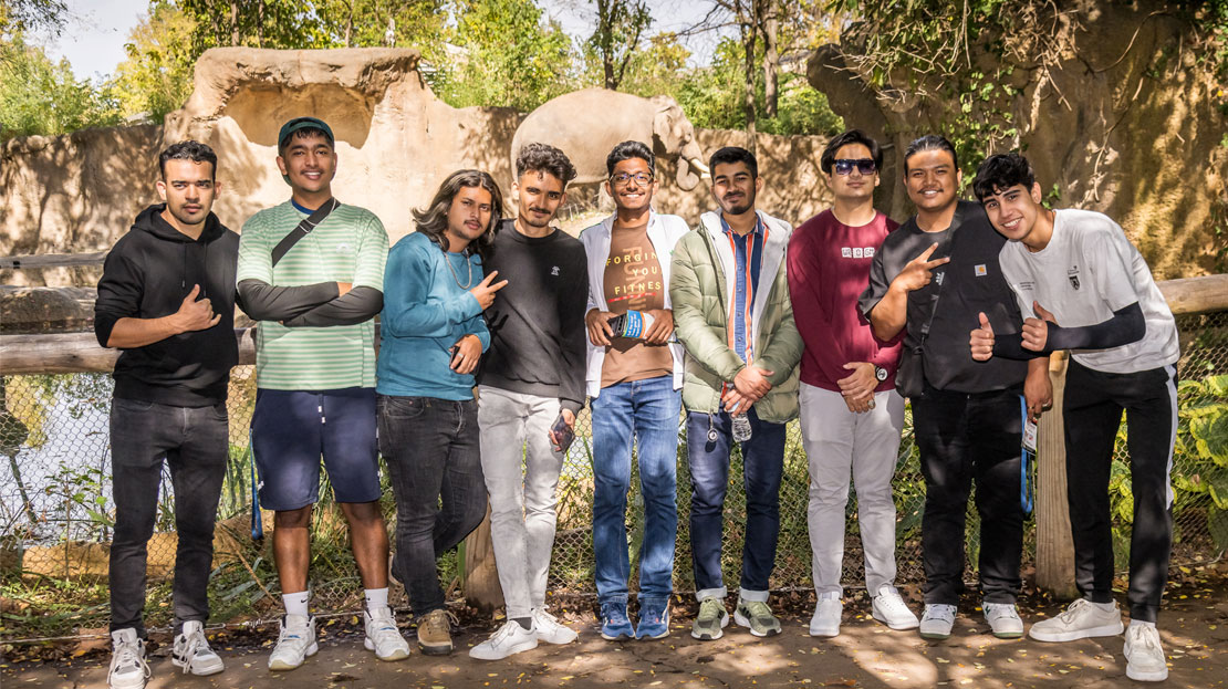 A group of 9 Webster students pose for a photo at the St. Louis Zoo.