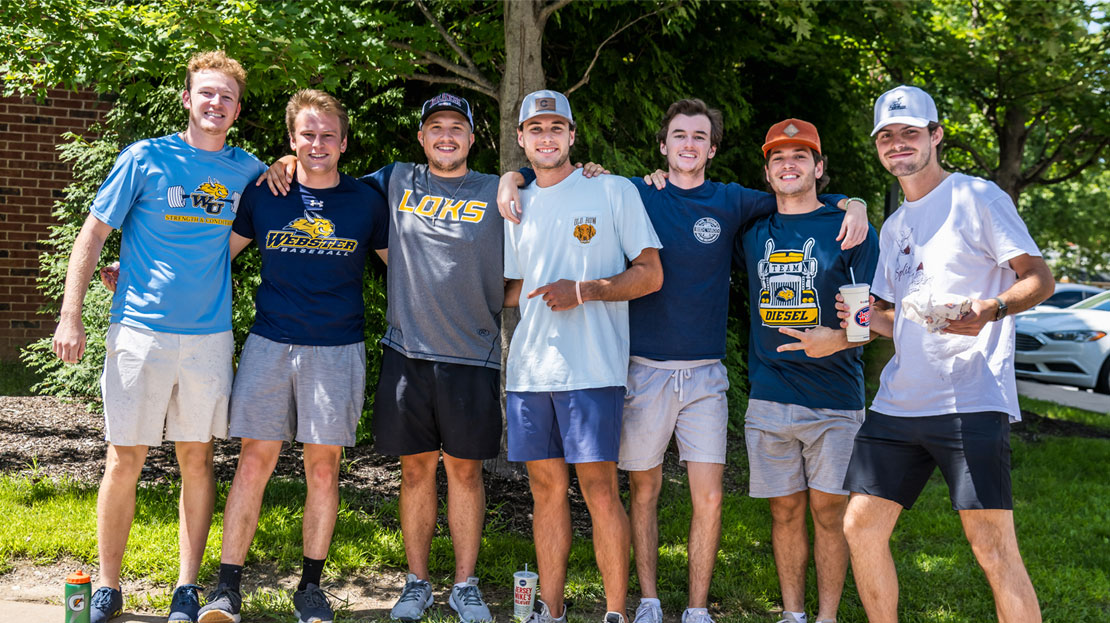 A group of Webster students posing together on move-in day.