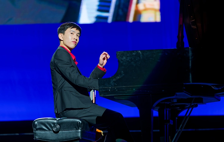 asher koh playing the piano