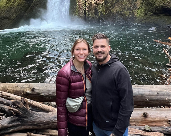 Preston Petri poses in front of a waterfall