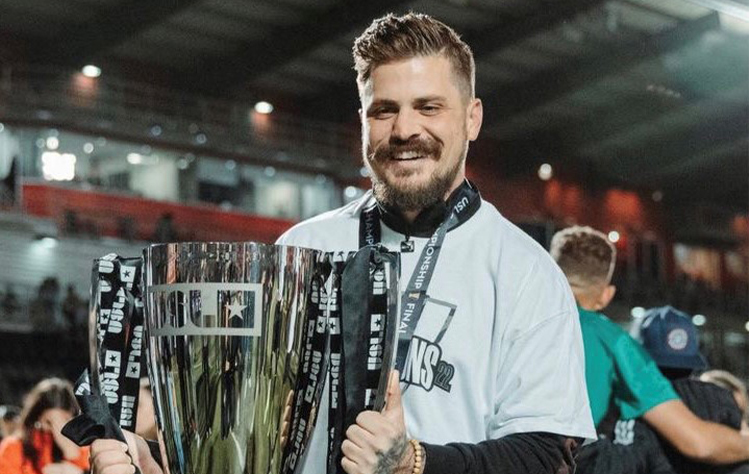 Preston Petri holding trophy following a soccer win