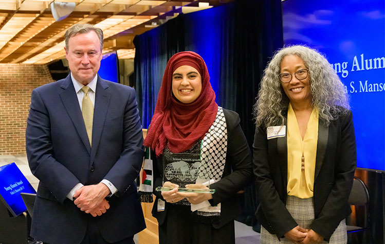 Hafsa Mansoor poses with her Young Alumni Award with Tim Keane and Linda Robinson.