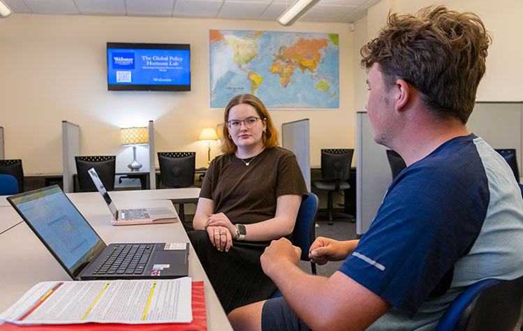 Two students working on research projects in the Global Policy Horizon's Lab in Webster Hall.