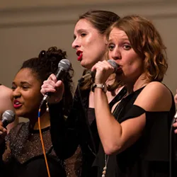 Webster Music students performing with microphones in an ensemble.