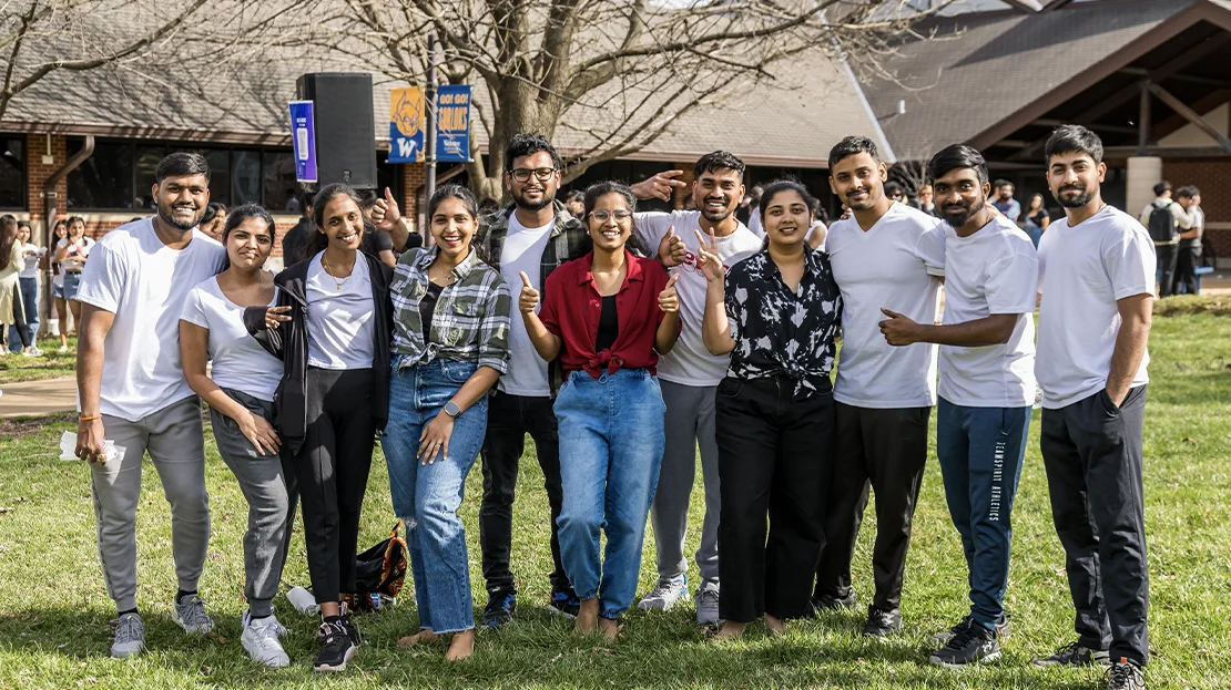A group of Webster students pose for a photo during an event. 